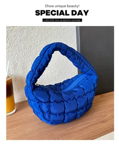 Blue quilted puffy underarm bag for women, stylish mini cloud handbag with zipper.