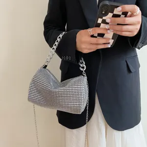 Detailed shot of a sparkling rhinestone evening bag with a stylish metal chain strap.