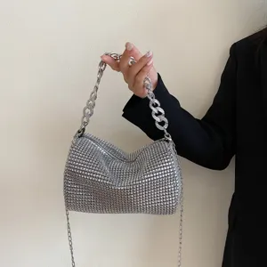 Detail view of the sparkly rhinestone evening bag with chunky metal chain handle and chic design.