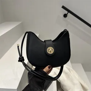Fashion minimalist black dumpling shoulder bag for women, chic crescent underarm bag.