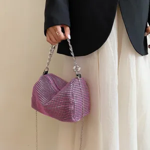 Close-up detail of the pink rhinestone slouchy hobo bag with a chunky silver chain handle.