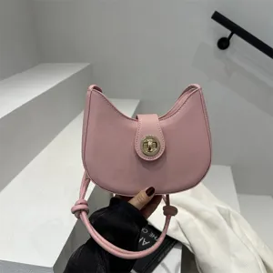 Minimalist pink crescent shoulder bag for women, stylish dumpling handbag with chic turn lock.