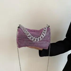 Pink rhinestone chain shoulder bag, sparkling evening handbag with chunky diamond strap detail.
