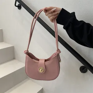 Pink PU leather shoulder bag detail showing stylish metal twist lock and slim strap design.
