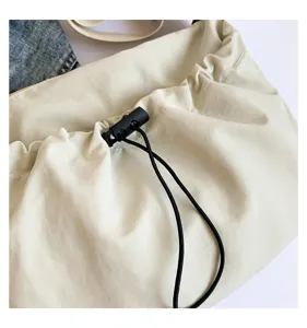Nylon Achseltasche Detail zeigt das plissierte Kordelzug Design und den schwarzen Stopp.
