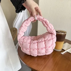 Pink quilted puffer cloud bag, chic minimalist mini underarm handbag for women style.
