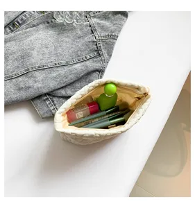 White quilted cosmetic pouch for women, soft travel makeup bag and stylish clutch organizer.