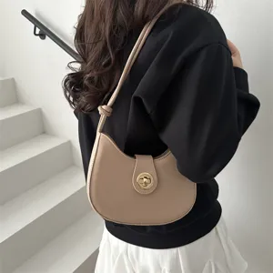 Detail shot of a minimalist beige shoulder bag, hobo dumpling purse for women, casual daily wear.