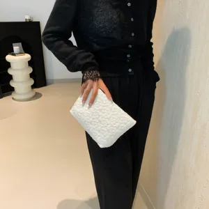 White quilted cosmetic clutch bag for women, stylish minimalist travel puffer purse main view