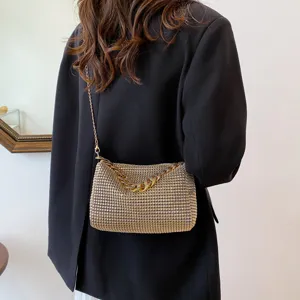 Stunning sparkly rhinestone chain evening bag detail, elegant gold shoulder crossbody accessory.