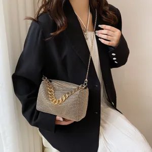 Detailed shot of a stylish rhinestone crossbody evening bag with a chunky gold chain strap.