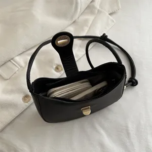 Stylish black hobo shoulder bag for women, minimalist underarm dumpling bag with gold lock.