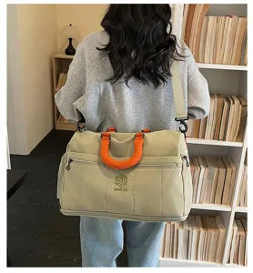 Large capacity travel duffel bag for women, lightweight gym and weekend luggage bag with shoulder strap.