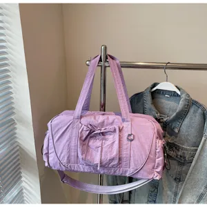 Detail view of a light purple waterproof gym duffel bag with spacious storage and strap.