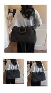 Large capacity travel duffel bag for short trips, lightweight black canvas handbag for gym storage.