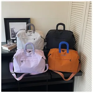 Detailed view of large capacity expandable travel bags in four stylish colors with handles.