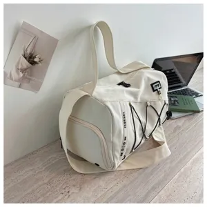 Canvas gym travel duffel bag detail showcasing side zipper, elastic cord and white finish.