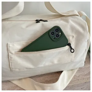 Large capacity duffel bag detail showing convenient front zipper pocket storage design.