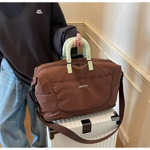 Detailed shot of large capacity travel duffel bag with stylish handles and crossbody strap.