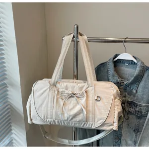 Beige gym duffel bag with bowknot pocket, large capacity sports training travel bag.
