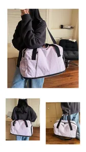 Large capacity travel duffel bag in light purple with black straps for gym and weekend trips.