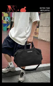 Large capacity travel duffel bag holding by model in urban street background detail view.