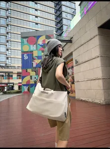 Large capacity travel bag in beige, ideal for short trips, gym, and daily commuting needs.