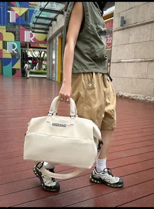 Large capacity travel duffel bag for women and men, canvas weekender bag with shoulder strap.