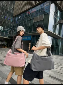 Large capacity travel duffel bag detail, durable waterproof fabric for fitness and business trips.
