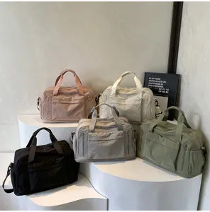 Large capacity travel duffel bag for women and men, multi-pocket sports gym luggage bag.
