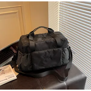 Large capacity black travel duffel bag with multiple pockets and durable fabric for gym and daily use.