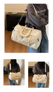 Large capacity travel duffel bag for women, casual cream shoulder bag and gym tote.