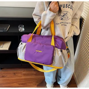 Large capacity purple travel duffel bag with yellow straps and side pockets for gym and sports.