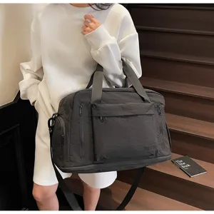 Large capacity black travel duffel bag for gym, fitness, and short trips with shoulder strap.