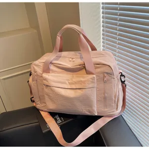 Pink travel duffel bag for women, large capacity gym yoga bag and portable flight luggage.