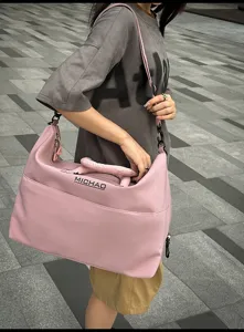 Large capacity travel duffel bag for women and men, stylish pink weekend luggage bag.