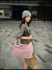Pink large capacity travel duffel bag for women, stylish weekend boarding luggage and fitness.
