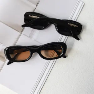 Chic narrow black frame sunglasses with gradient lenses and metal temple detail for street style.