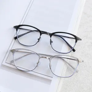 Metal retro eyeglasses frame detail view showing stylish black and clear double frame design.