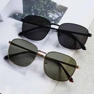 Detail view of retro metal square sunglasses with dual color frames and tinted lenses.