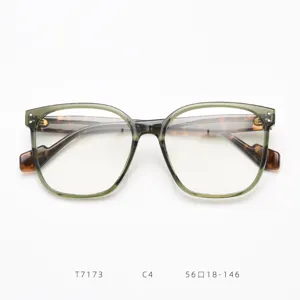 Close-up detail shot of trendy oversized optical glasses frame with green translucent front.