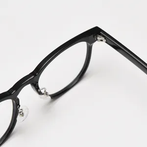 Detail view of Japanese style retro black eyeglasses frame, delicate hinge and clear nose pads.