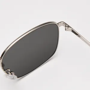 Vintage metal frame square sunglasses detail view, stylish and sleek eyewear accessory.
