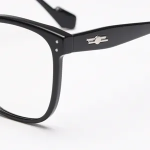 Close-up detail of black acetate optical frame, highlighting the sleek temple metal hardware.