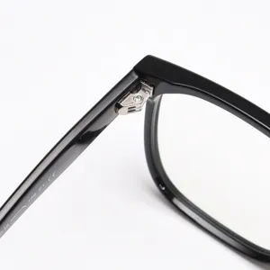 Detailed view of the durable metal hinge and sleek black acetate temple on optical frames.