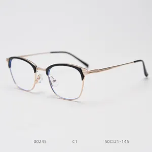 Close-up detail of vintage metal semi-rimless optical glasses frame in black and gold.