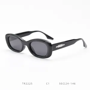 Black oval frame sunglasses detail view featuring stylish chunky design and metal temple accent.