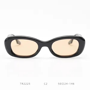 Black retro oval sunglasses detail showing light brown lenses and stylish streetwear design.