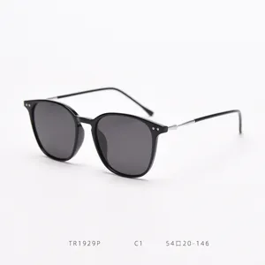Close-up of black square sunglasses with metallic temples and dark lenses for daily style.