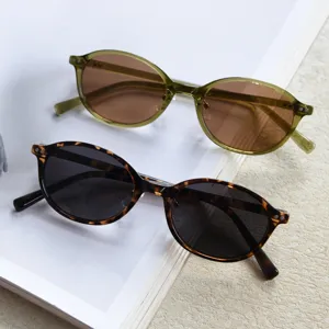 Detailed view of two pairs of retro small oval TR90 polarized sunglasses in green and tortoise.